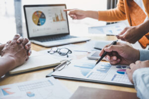 Business team collaboration discussing working analyzing with fi Business team collaboration discussing working analyzing with financial data and marketing growth report graph in team, presentation and brainstorming to strategy planning making profit of company.