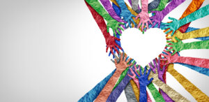 United Diversity United diversity and unity partnership as heart hands in a group of diverse people connected together shaped as a support symbol expressing the feeling of teamwork and togetherness.